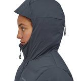 A close up of a woman wearing the hood of the Patagonia Women's Jackson Glacier Jacket in a Smolder Blue colour up. 