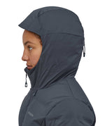 A close up of a woman wearing the hood of the Patagonia Women's Jackson Glacier Jacket in a Smolder Blue colour up. 