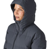 Woman wearing Patagonia Jackson Glacier Parka with hood up and zip fastened up to the chin for maximum insulation.
