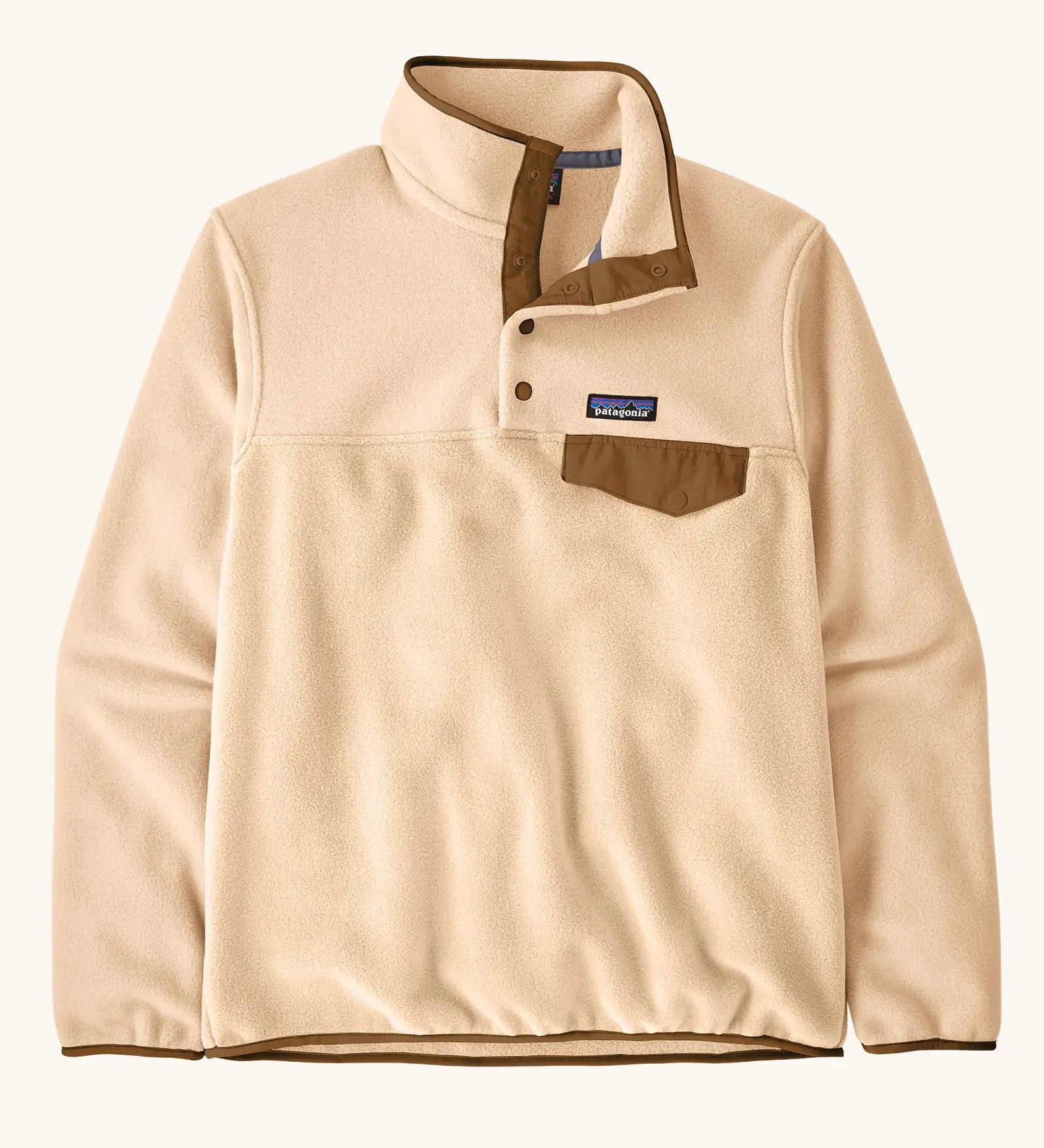 Patagonia women's lightweight synchilla fleece snap-t pullover in natural with brown chest pocket and bininding in sleeves and collar.