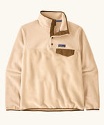 Patagonia women's lightweight synchilla fleece snap-t pullover in natural with brown chest pocket and bininding in sleeves and collar.