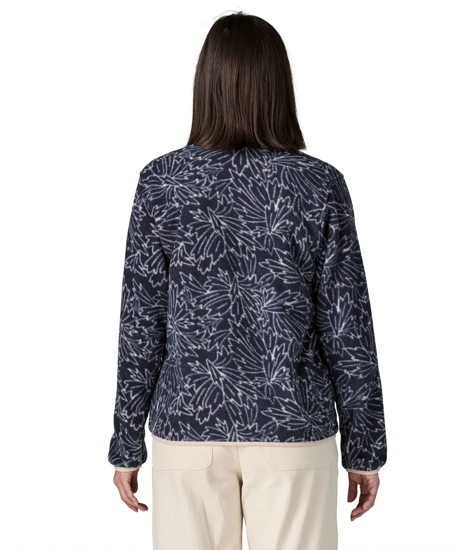 Back of woman wearing the Patagonia women's lightweight synchilla fleece snap-T pullover with a saxifrage pattern in a sunken blue colour. 