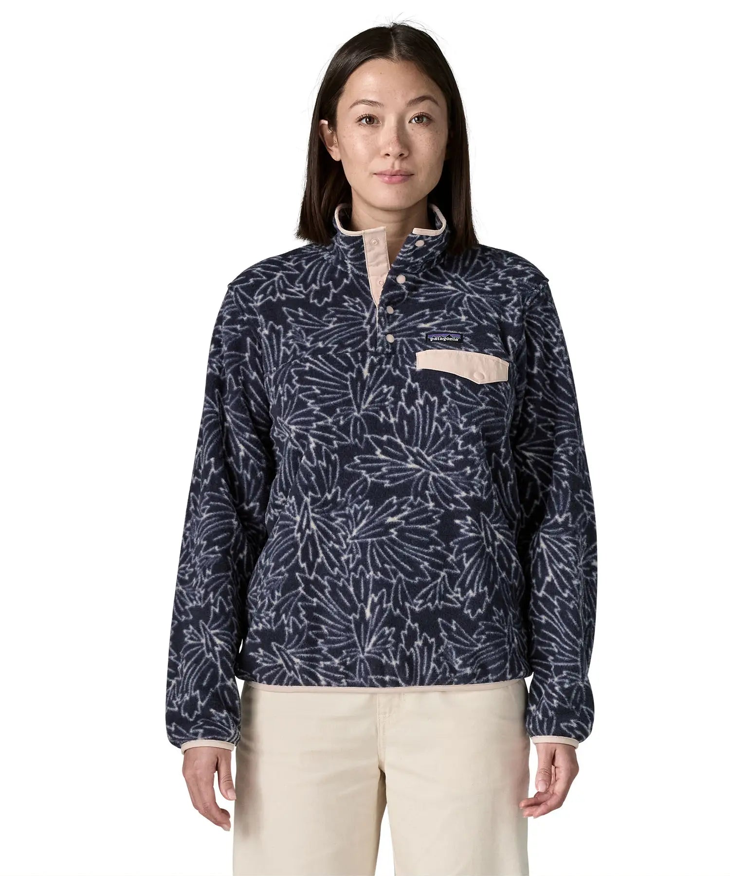 Woman wearing the Patagonia women's lightweight synchilla fleece snap-T pullover with a saxifrage pattern in a sunken blue colour. 