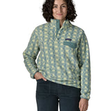 Woman wearing the Patagonia women's lightweight synchilla fleece snap-T pullover in a sun Quilt pattern in blue sage with the poppered neck closure open.