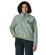 Woman wearing the Patagonia women's lightweight synchilla fleece snap-T pullover in a sun Quilt pattern in blue sage with the poppered neck closure open.