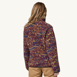 A woman models the back of the Patagonia Women's Lightweight Synchilla Snap-T Fleece Pullover - against a plain background.