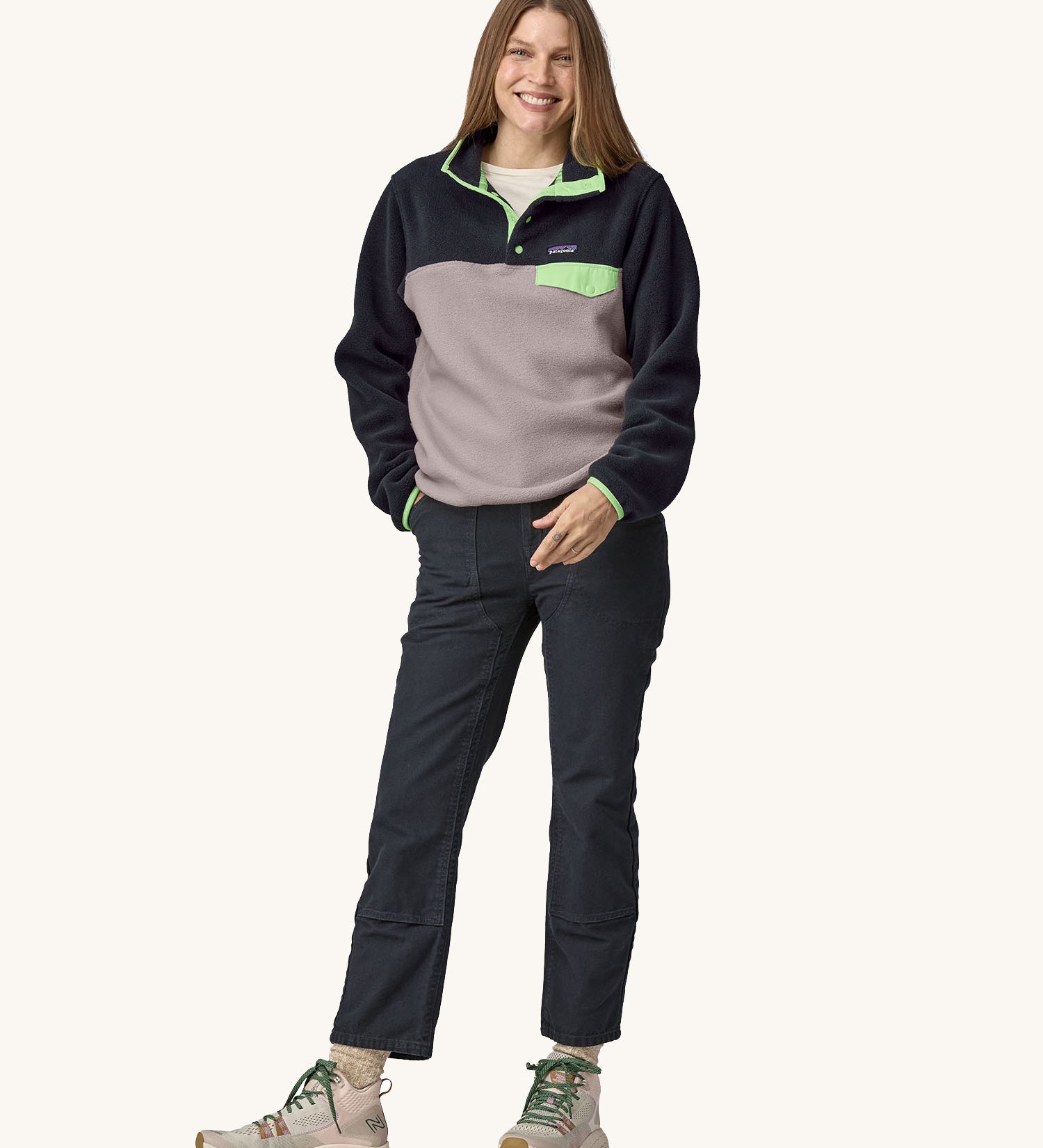 A woman wearing a Patagonia Women's Lightweight Synchilla Snap-T Fleece in an Echo Purple colour.