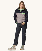 A woman wearing a Patagonia Women's Lightweight Synchilla Snap-T Fleece in an Echo Purple colour.