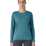 Patagonia women's long sleeve capilene top in turquoise beach outline design worn by a woman front detail