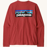 Patagonia women's responsibilli top in potters red. A long sleeve top with a large brand patch printed on the back 