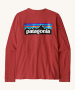 Patagonia women's responsibilli top in potters red. A long sleeve top with a large brand patch printed on the back 