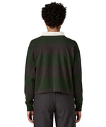 Woman waering a Patagonia women's long sleeved wide stripe rugby shirt in dark green showing the back of the top.