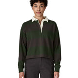 Woman waering a Patagonia women's long sleeved wide stripe rugby shirt in dark green.