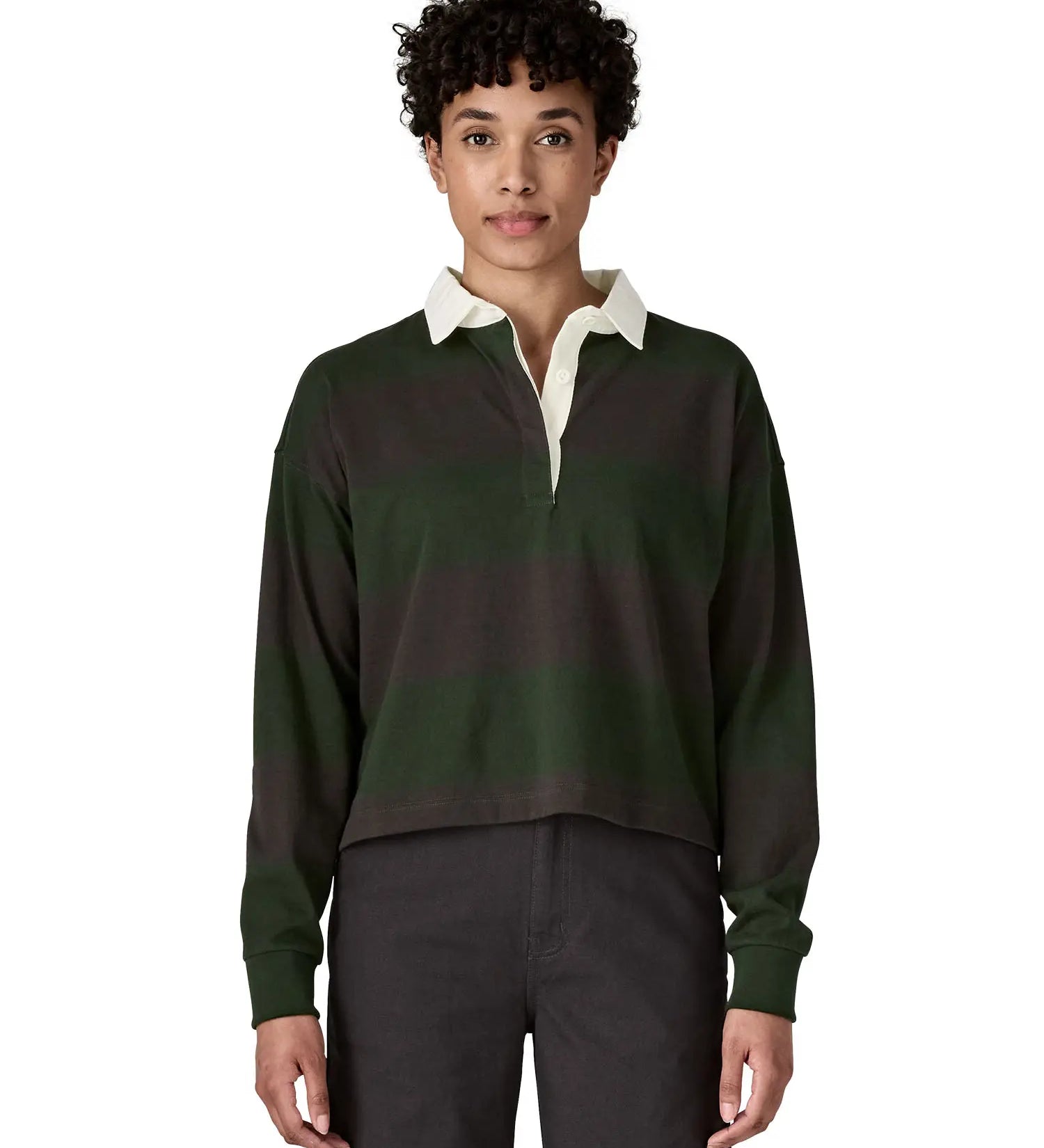 Woman waering a Patagonia women's long sleeved wide stripe rugby shirt in dark green.