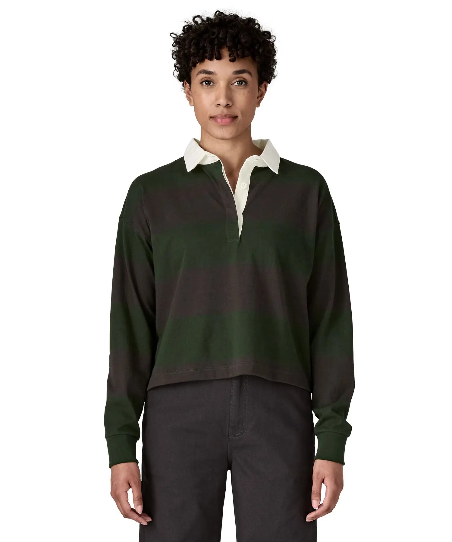 Woman waering a Patagonia women's long sleeved wide stripe rugby shirt in dark green.
