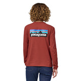 Back of woman wearing Patagonia Long Sleeved Responsibili-Tee in red with a large Patagonia logo across the back - made from recycled cotton and post-consumer recycled polyester - the lowest carbon footprint t-shirt.