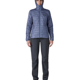 Patagonia Women's Nano Puff Hoody Jacket Current Blue lightweight insulated jacket worn zipped up by model with hood up full body view