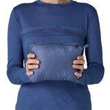 Patagonia Women's Nano Puff Hoody Jacket Current Blue packed into internal chest pocket stuffsack held in hands