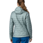 A woman wearing a Patagonia Women's Nano Puff Hoody in Thermal Blue showing the back of the jacket