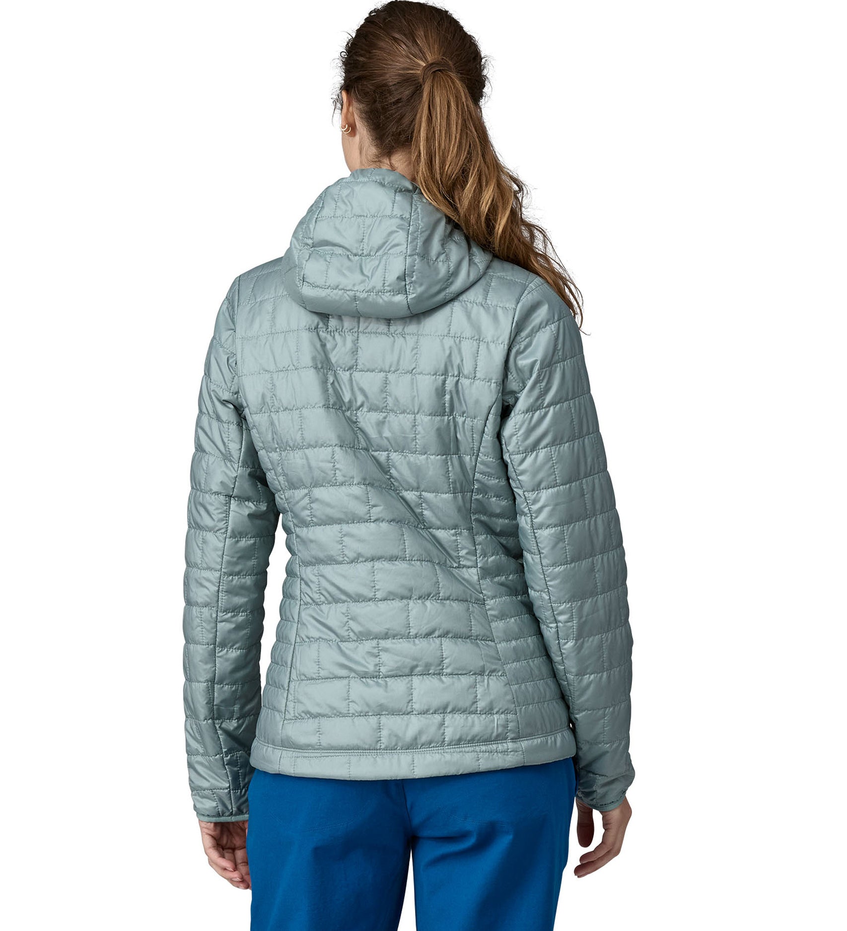 A woman wearing a Patagonia Women's Nano Puff Hoody in Thermal Blue showing the back of the jacket
