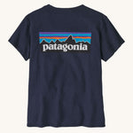 Patagonia women's short sleeve top in navy back logo detail on a cream background.