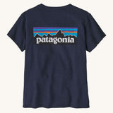 Patagonia women's short sleeve top in navy back logo detail on a cream background.