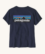 Patagonia women's short sleeve top in navy back logo detail on a cream background.