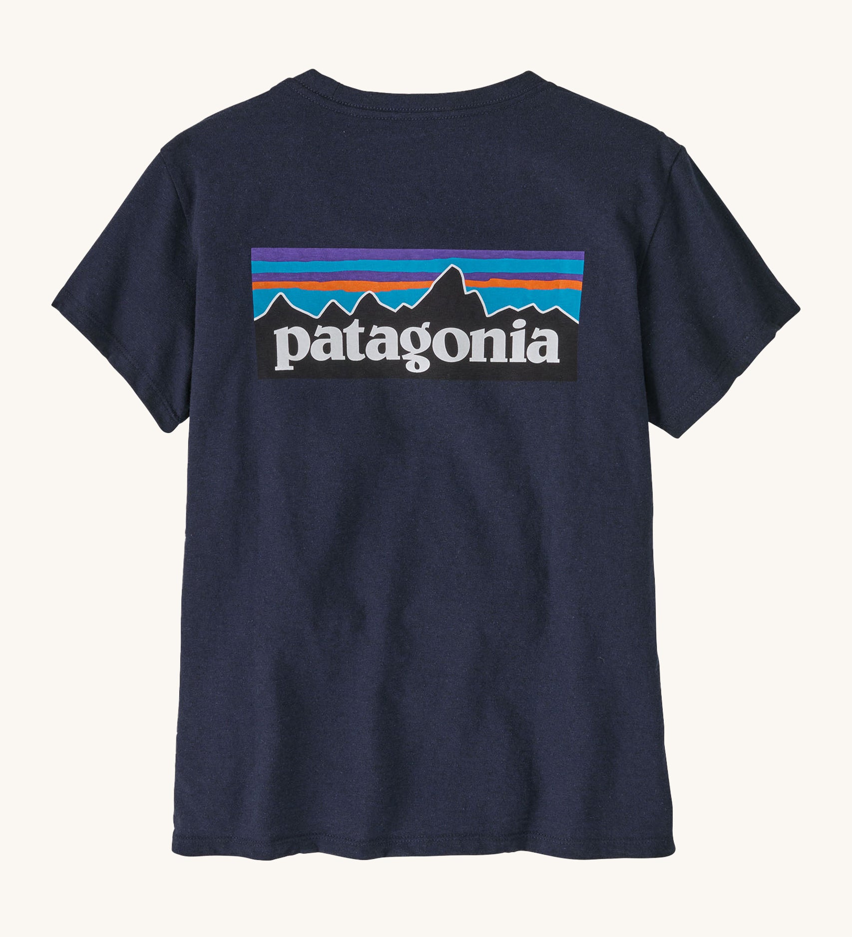 Patagonia women's short sleeve top in navy back logo detail on a cream background.