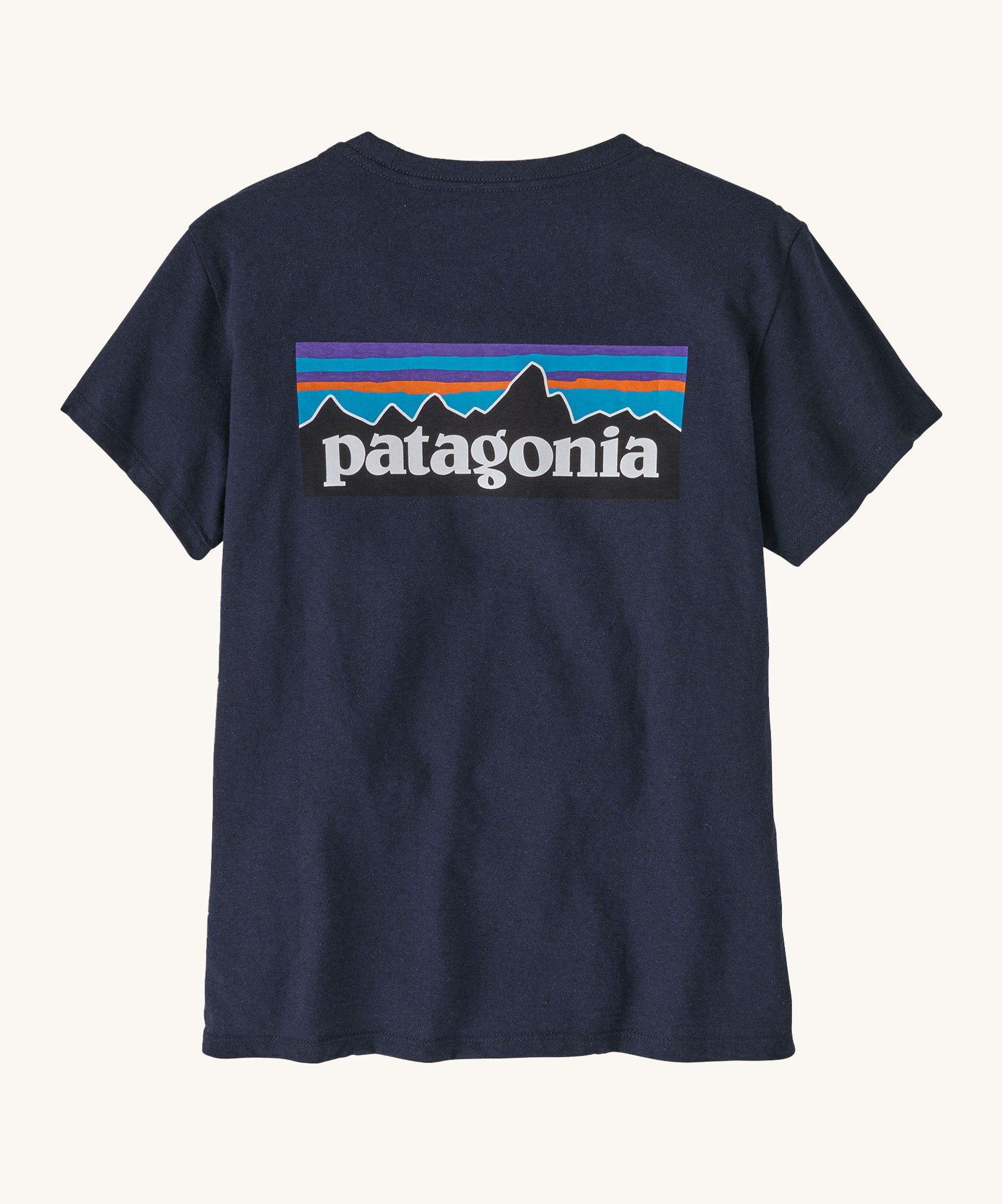 Patagonia women's short sleeve top in navy back logo detail on a cream background.