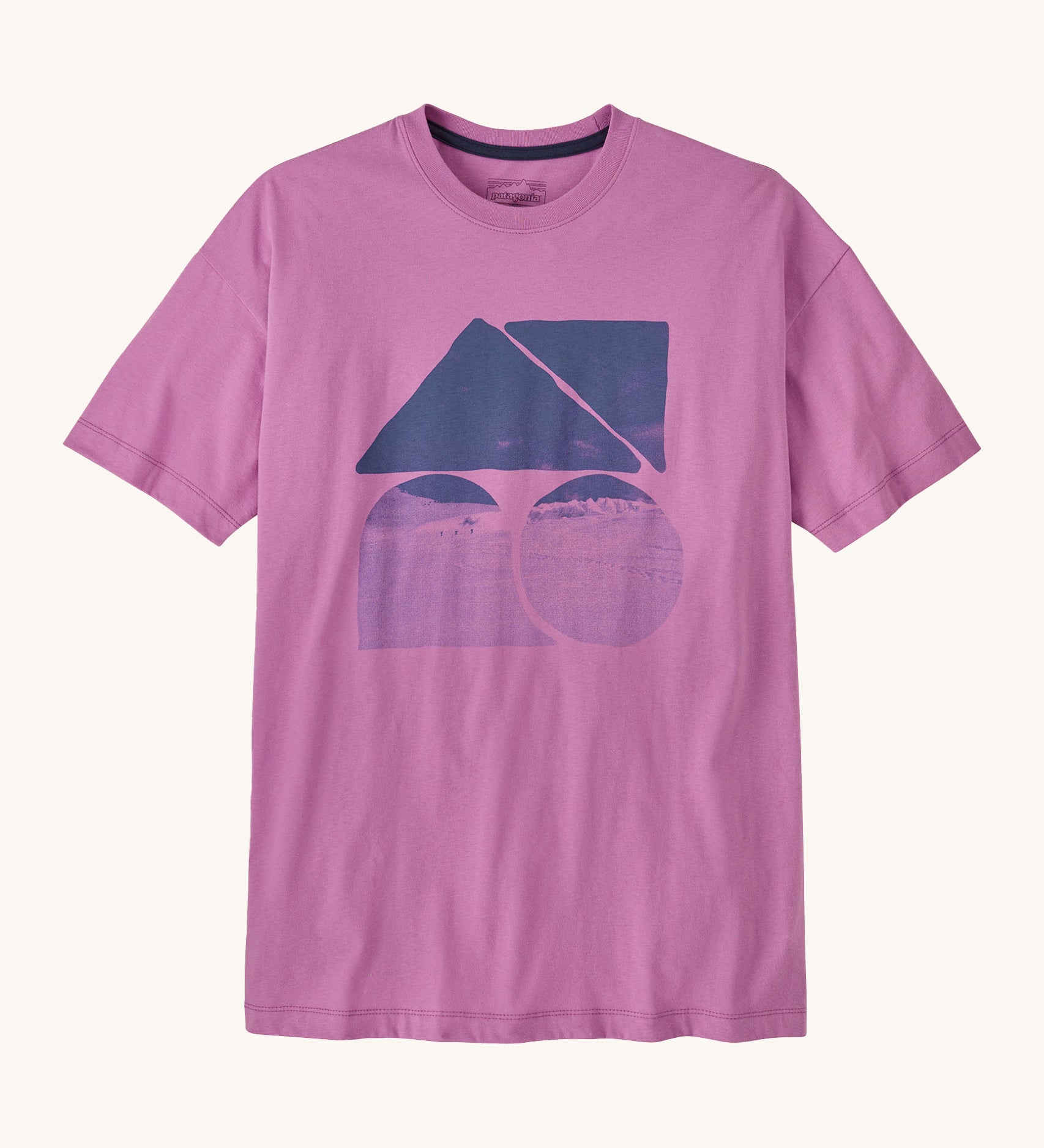 Patagonia women's oversized driftways t-shirt. A bright pink/purple top with short sleeves and a landscape print behind different shapes on the front.
