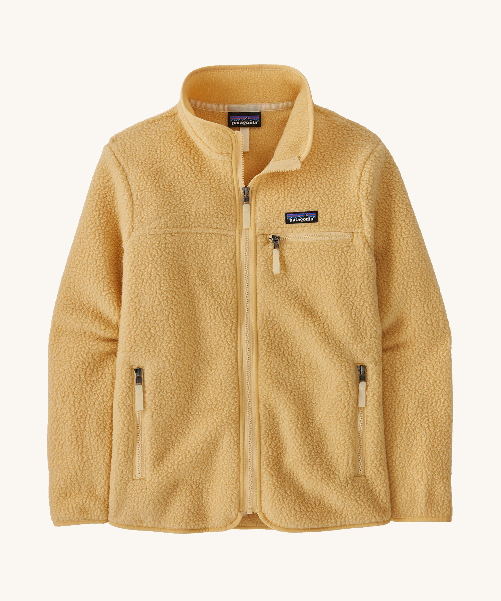 patagonia womens retro pile fleece jacket in a light brown colour on a cream background.