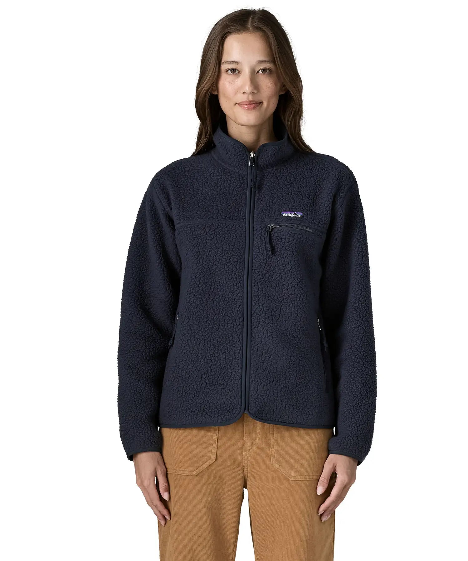 Woman wearing Patagonia women's retro pile fleece jacket in sunken blue with zippered chest pocket and handwarmer pockets.