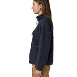 Side view of woman wearing Patagonia women's retro pile fleece jacket in sunken blue with zippered chest pocket and handwarmer pockets.