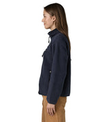 Side view of woman wearing Patagonia women's retro pile fleece jacket in sunken blue with zippered chest pocket and handwarmer pockets.