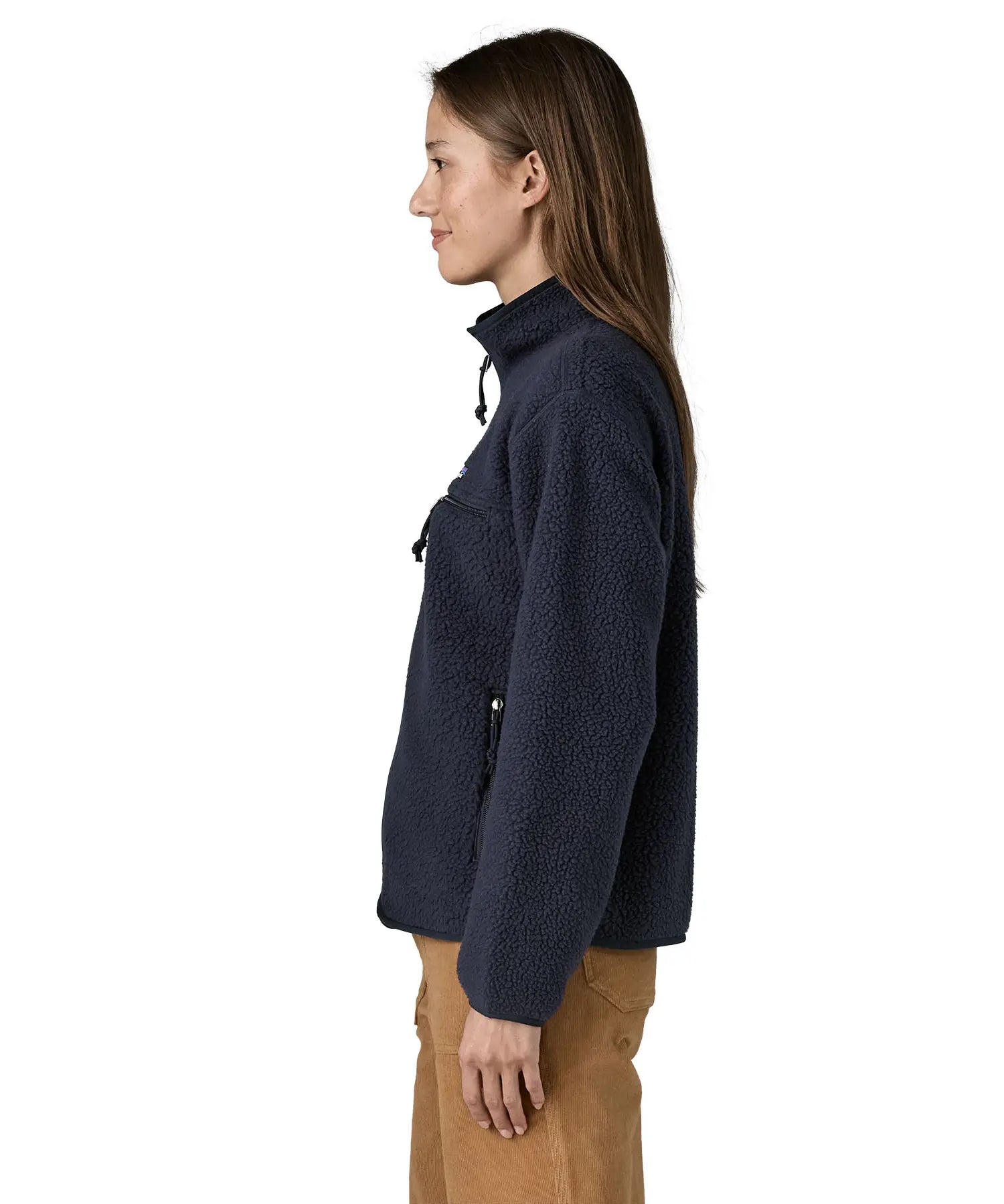 Side view of woman wearing Patagonia women's retro pile fleece jacket in sunken blue with zippered chest pocket and handwarmer pockets.