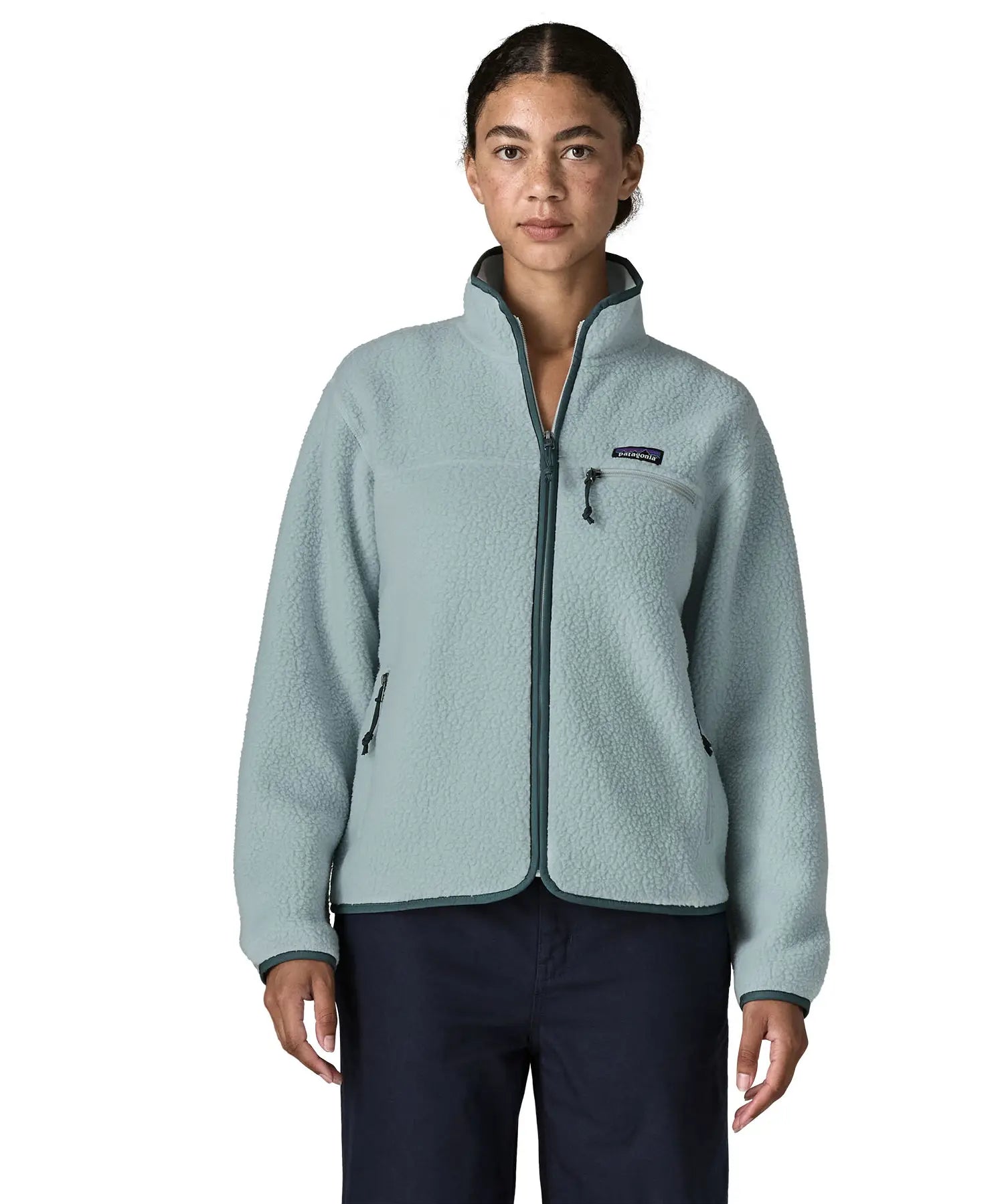 Woman wearing the Patagonia women's retro pile fleece jacket in virtually blue. Full zip fleece jacket with zippererd chest and hand warmer pockets.