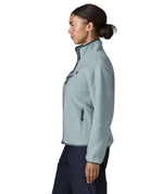 Side of woman wearing the Patagonia women's retro pile fleece jacket in virtually blue. Full zip fleece jacket with zippererd chest and hand warmer pockets.