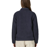 Back of a woman wearing the Patagonia women's retro pile fleece marsupial top in dark sunken blue.