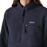 Close up of half zip closure and zippered chest pocket on the Patagonia women's retro pile fleece marsupial top in dark sunken blue.