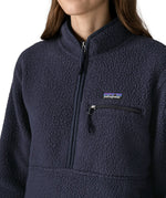Close up of half zip closure and zippered chest pocket on the Patagonia women's retro pile fleece marsupial top in dark sunken blue.