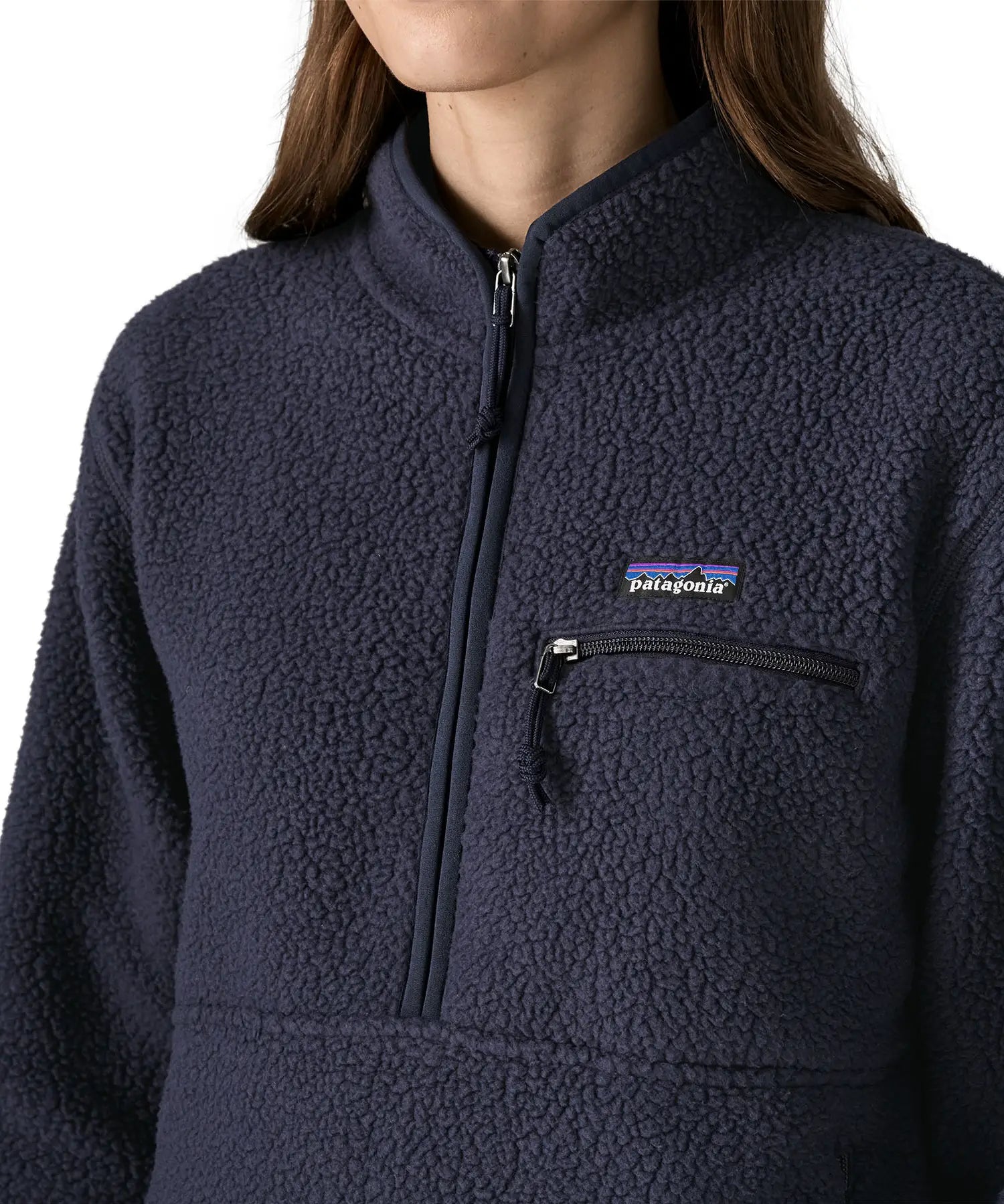 Close up of half zip closure and zippered chest pocket on the Patagonia women's retro pile fleece marsupial top in dark sunken blue.