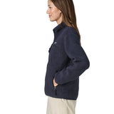Side view of a woman wearing the Patagonia women's retro pile fleece marsupial top in dark sunken blue.