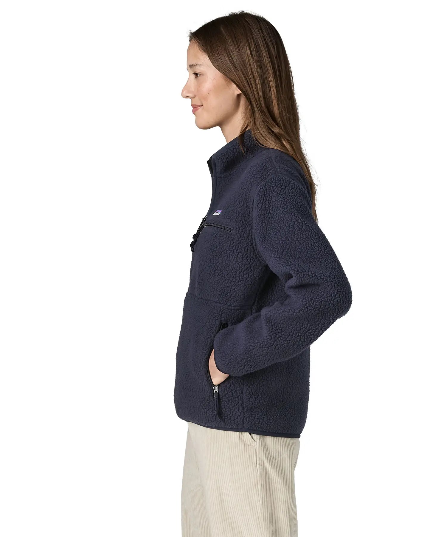 Side view of a woman wearing the Patagonia women's retro pile fleece marsupial top in dark sunken blue.