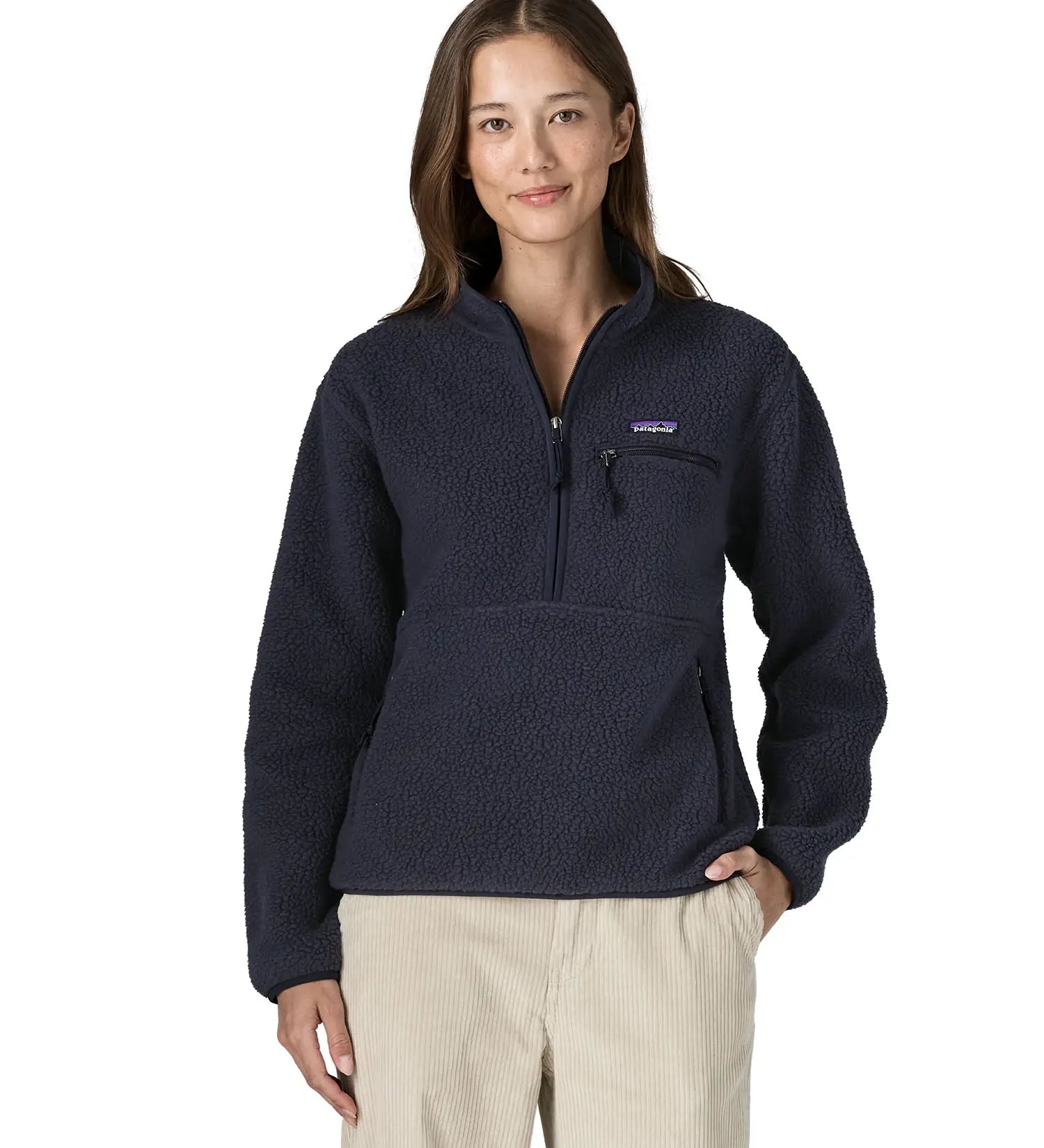 Woman wearing the Patagonia women's retro pile fleece marsupial top in dark sunken blue.