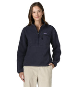 Woman wearing the Patagonia women's retro pile fleece marsupial top in dark sunken blue.