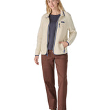 A woman wearing the Patagonia women's retro pile fleece i natural colour available at Babipur. A thick light purple fleece with a contrast blue trim. Features a full length zip, 2 side pockets and a chest pocket