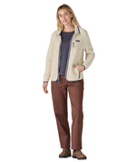 A woman wearing the Patagonia women's retro pile fleece i natural colour available at Babipur. A thick light purple fleece with a contrast blue trim. Features a full length zip, 2 side pockets and a chest pocket