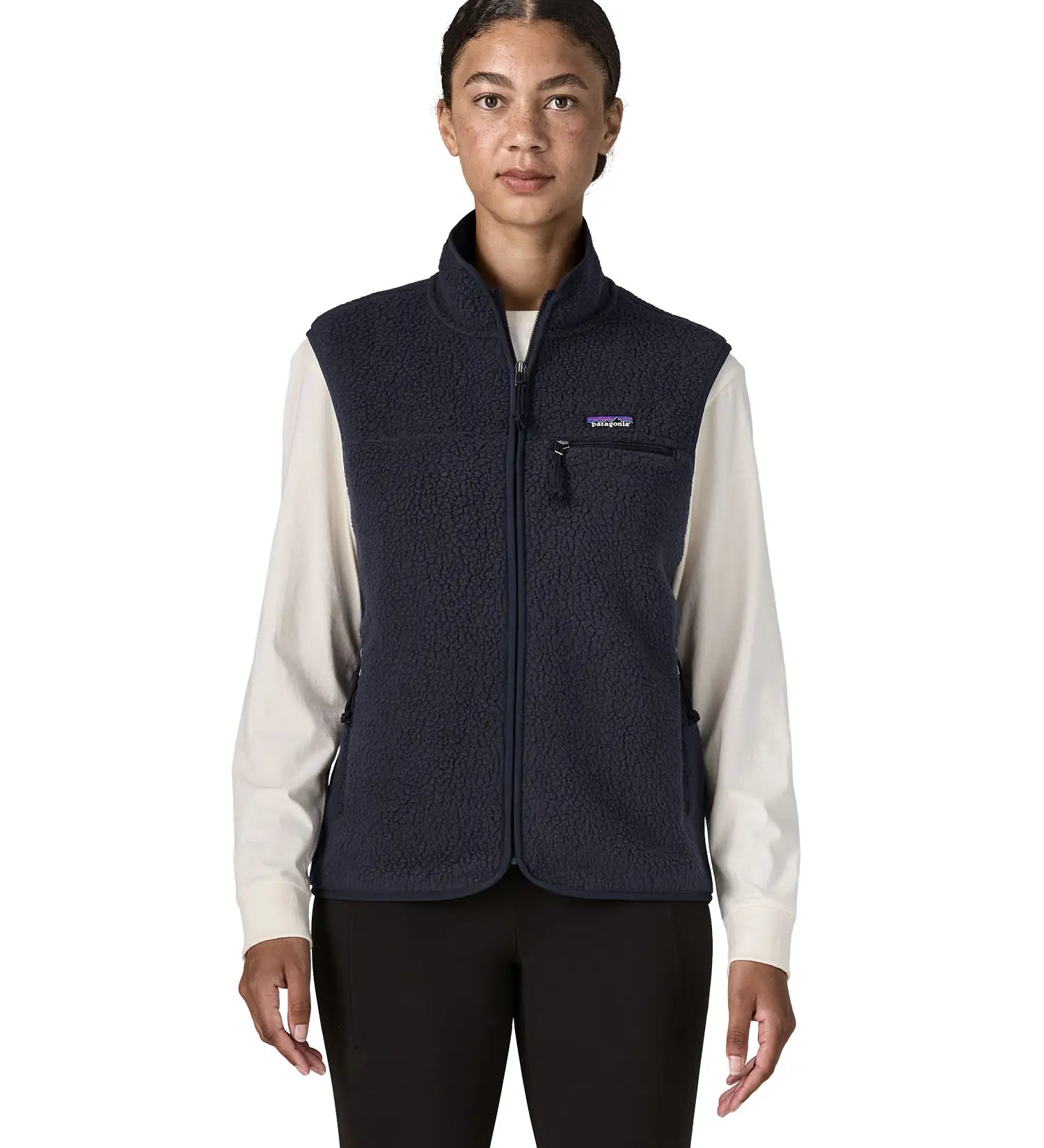 Woman wearing the Patagonia women's retro pile fleece vest gilet in sunken blue. Full length zip gilet with zippered chest and hand warmer pockets.