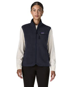 Woman wearing the Patagonia women's retro pile fleece vest gilet in sunken blue. Full length zip gilet with zippered chest and hand warmer pockets.