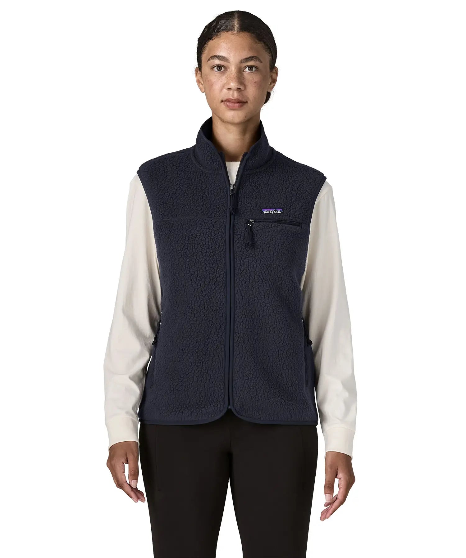 Woman wearing the Patagonia women's retro pile fleece vest gilet in sunken blue. Full length zip gilet with zippered chest and hand warmer pockets.